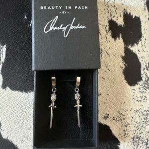 Small dagger hoop earrings by Charly Jordan.